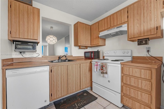 kitchen with pendant lighting, white appliances, sink, a textured ceiling, and light tile patterned flooring