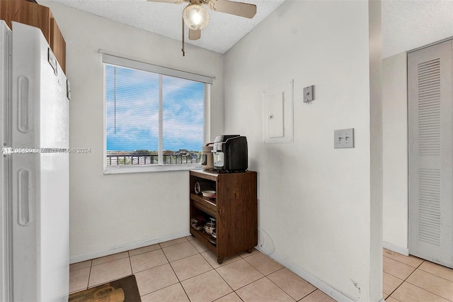 tiled home office with electric panel, ceiling fan, and a textured ceiling