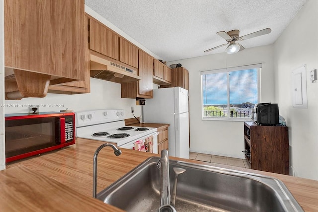 kitchen featuring a textured ceiling, white appliances, ceiling fan, and sink