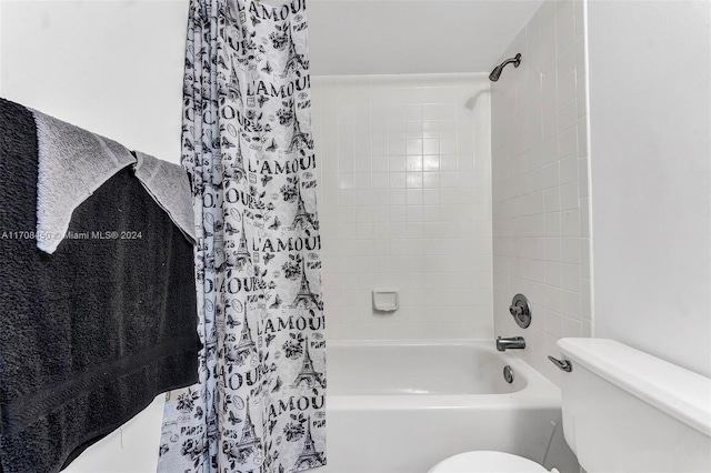 bathroom with toilet and shower / tub combo with curtain