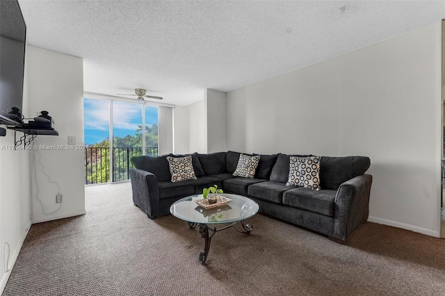 carpeted living room featuring floor to ceiling windows, a textured ceiling, and ceiling fan