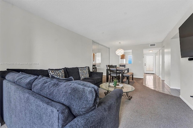 living room featuring carpet and a textured ceiling