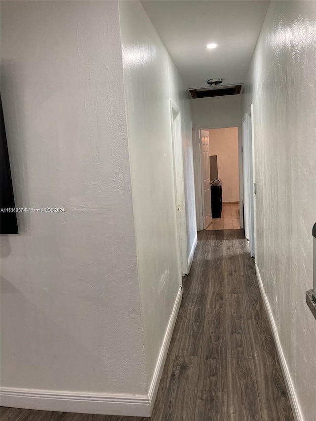 hallway with dark hardwood / wood-style flooring