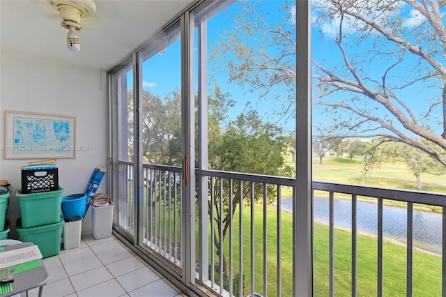 sunroom / solarium featuring a water view