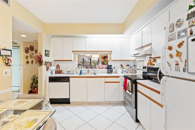 kitchen featuring sink, white cabinets, light tile patterned flooring, and white appliances