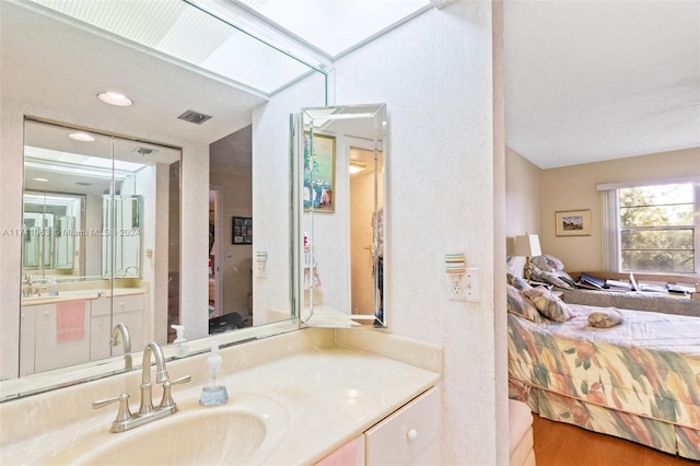 bathroom with hardwood / wood-style floors and vanity