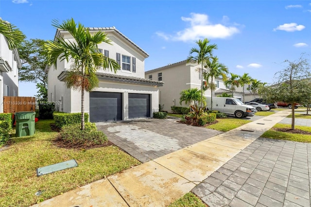 view of front of house featuring a garage and a front lawn