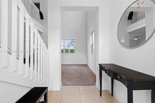 hall featuring light tile patterned flooring