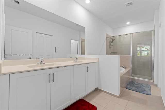 bathroom featuring tile patterned flooring, shower with separate bathtub, and vanity