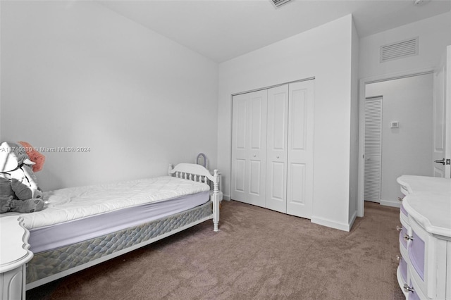 carpeted bedroom with a closet