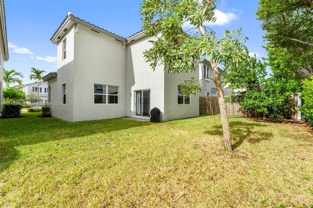 back of house with a lawn