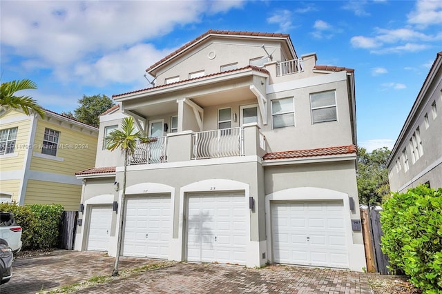 view of front of house featuring a balcony and a garage