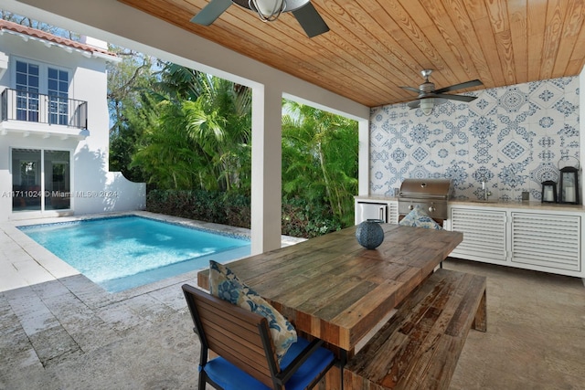 view of swimming pool with area for grilling, ceiling fan, and a patio area