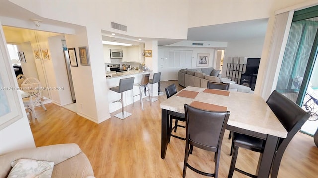 dining space with light hardwood / wood-style flooring