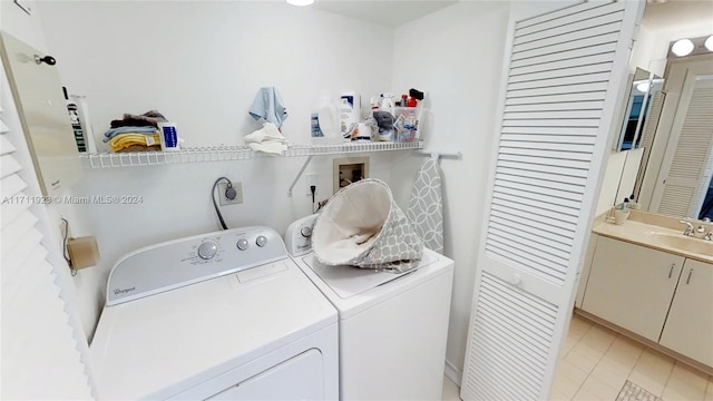 washroom featuring washer and dryer and sink