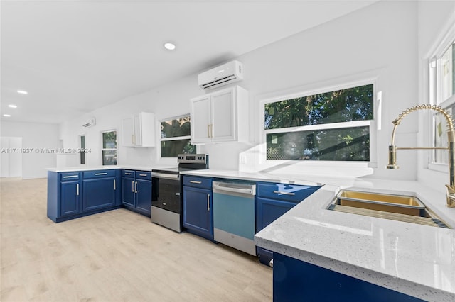 kitchen with white cabinetry, sink, stainless steel appliances, a wall unit AC, and light wood-type flooring