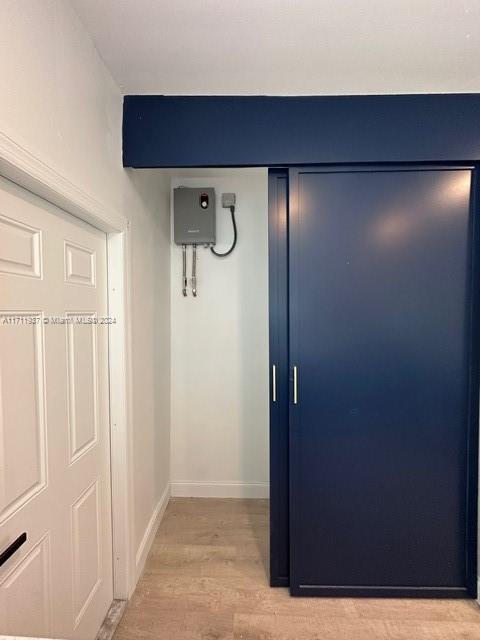 hallway with light hardwood / wood-style flooring