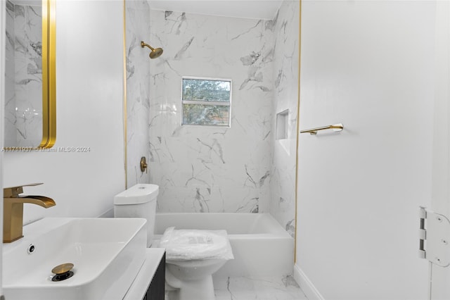 full bathroom featuring vanity, tiled shower / bath combo, and toilet