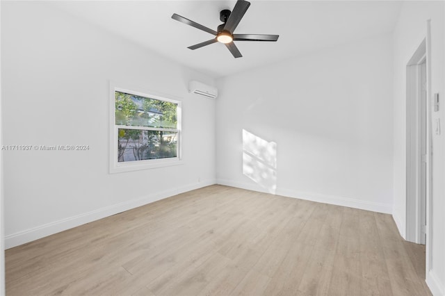 empty room with a wall unit AC, ceiling fan, and light hardwood / wood-style flooring