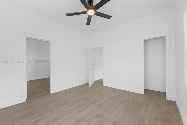 unfurnished bedroom featuring a closet, light hardwood / wood-style flooring, and ceiling fan