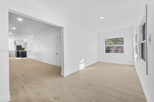 empty room with light hardwood / wood-style flooring