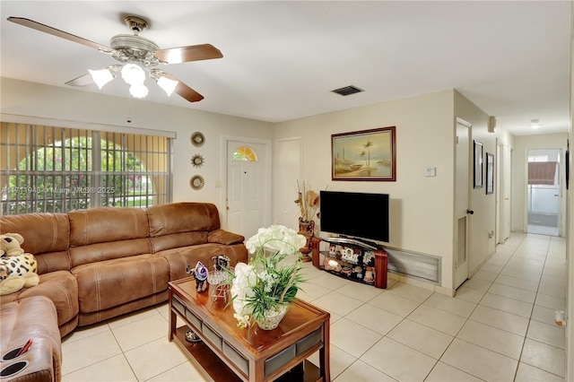 tiled living room with ceiling fan