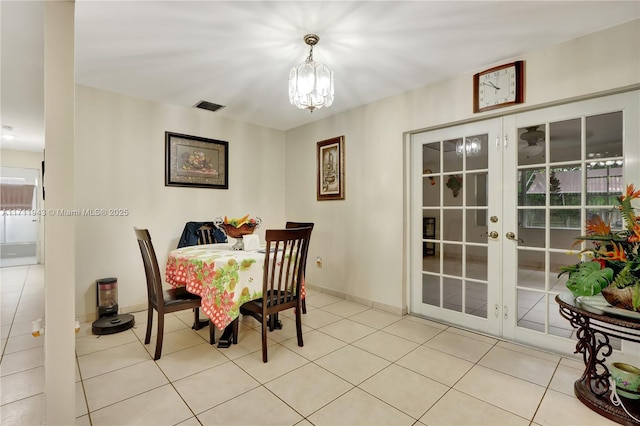 dining area with light tile patterned floors and a notable chandelier