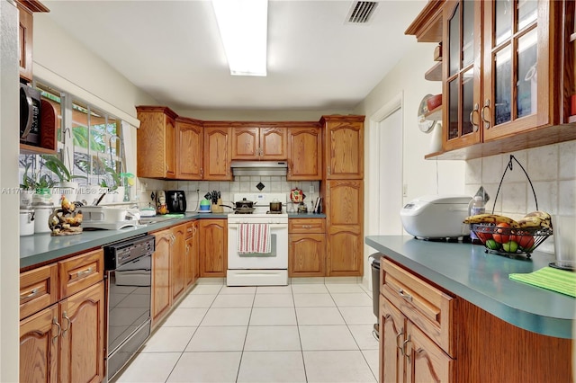 kitchen with white range oven, dishwasher, tasteful backsplash, and light tile patterned floors