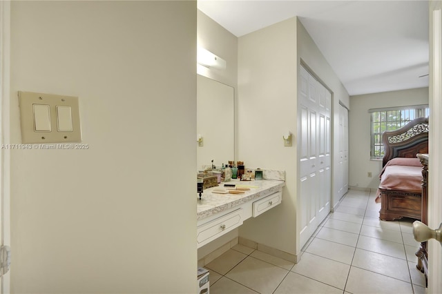 bathroom with tile patterned floors and vanity