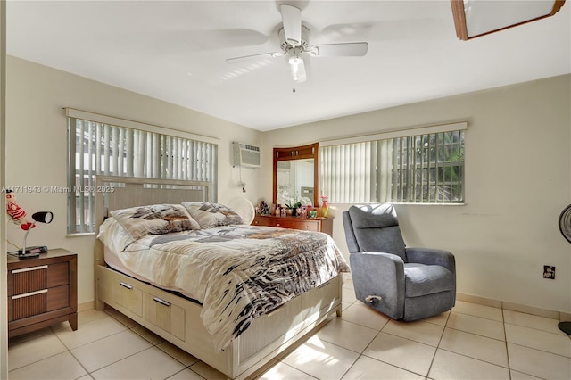 bedroom with ceiling fan, light tile patterned flooring, and a wall unit AC