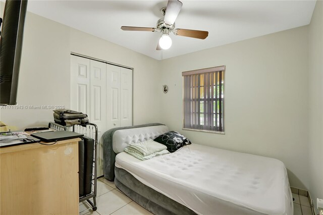 bedroom with ceiling fan and light tile patterned floors