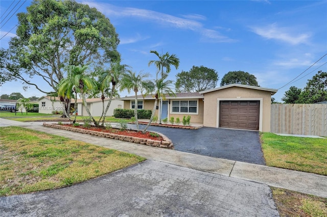 single story home with a front lawn and a garage