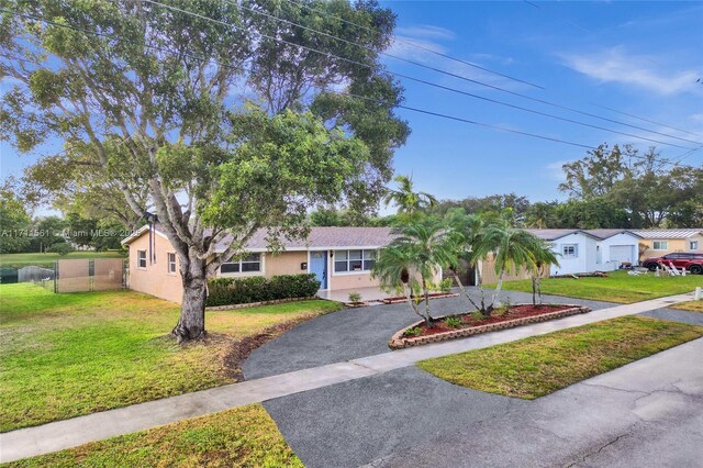 ranch-style home with a front lawn