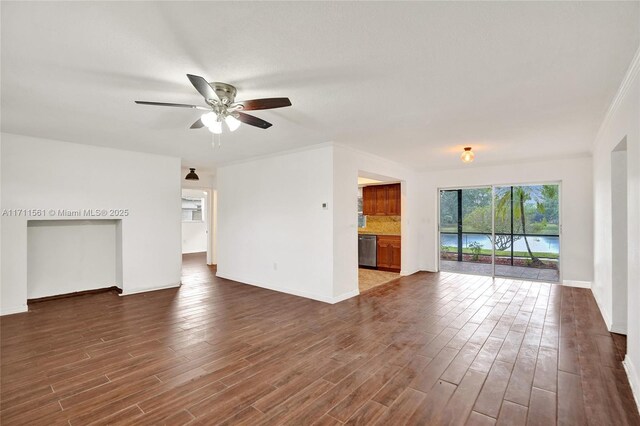 unfurnished living room featuring ceiling fan, dark hardwood / wood-style flooring, and crown molding