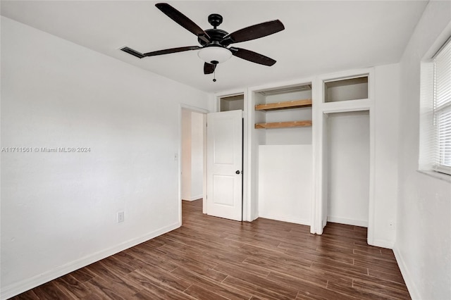 unfurnished bedroom with ceiling fan and dark hardwood / wood-style floors