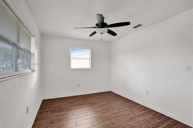 spare room featuring ceiling fan and dark hardwood / wood-style flooring