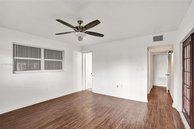 unfurnished room with dark hardwood / wood-style flooring and ceiling fan