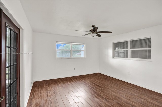 unfurnished room featuring ceiling fan and dark hardwood / wood-style flooring