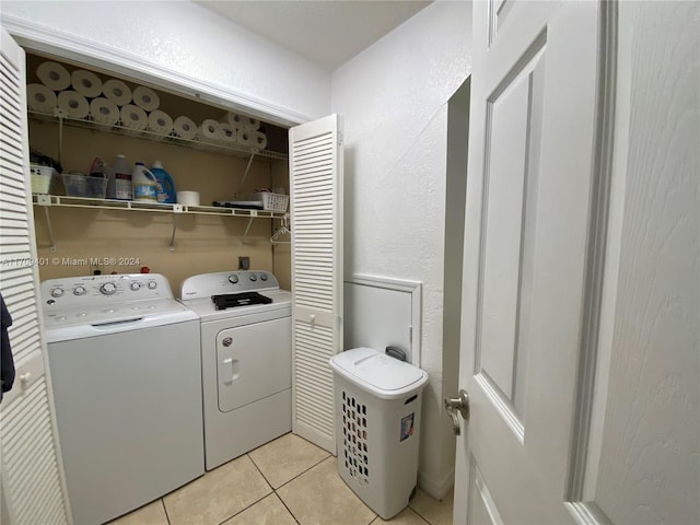 washroom featuring independent washer and dryer and light tile patterned floors