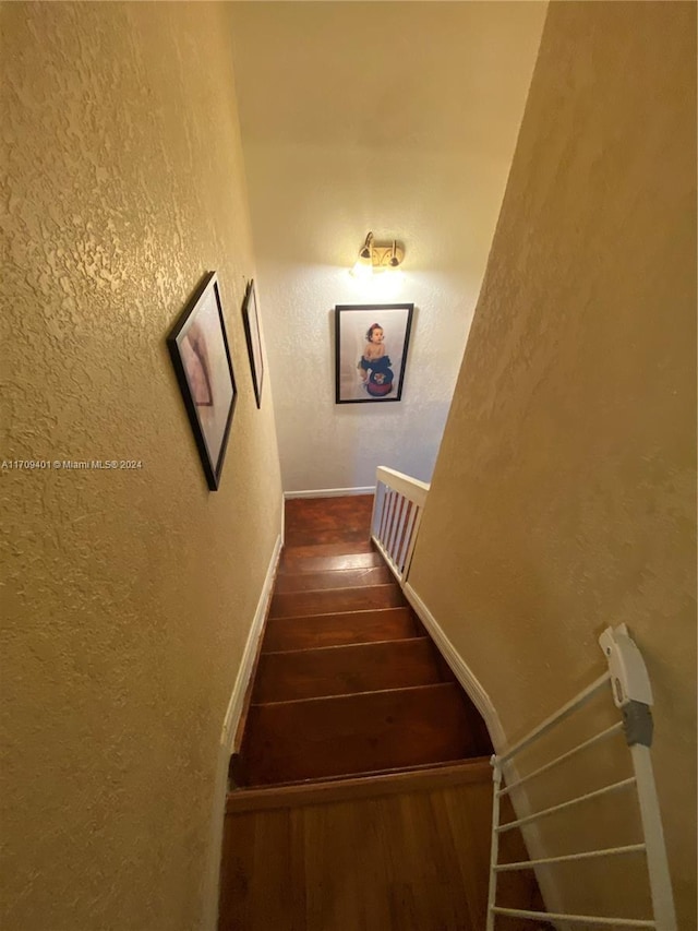 staircase featuring hardwood / wood-style floors