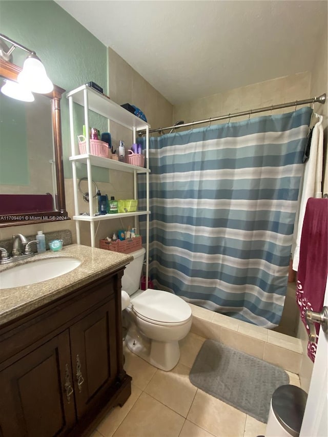 bathroom featuring tile patterned floors, vanity, a shower with shower curtain, and toilet