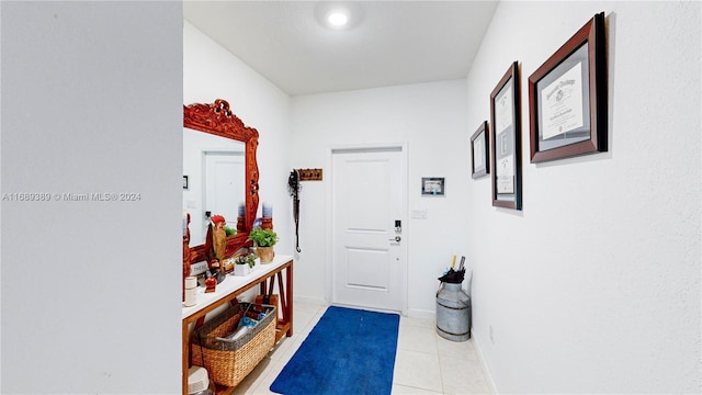 doorway with light tile patterned floors