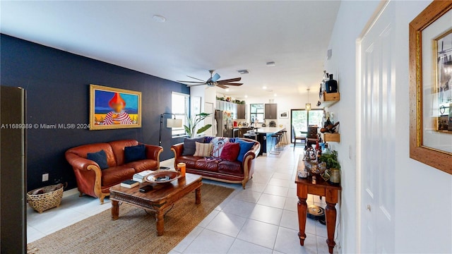 living room with ceiling fan and light tile patterned floors