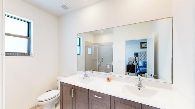 bathroom with vanity, toilet, and an enclosed shower