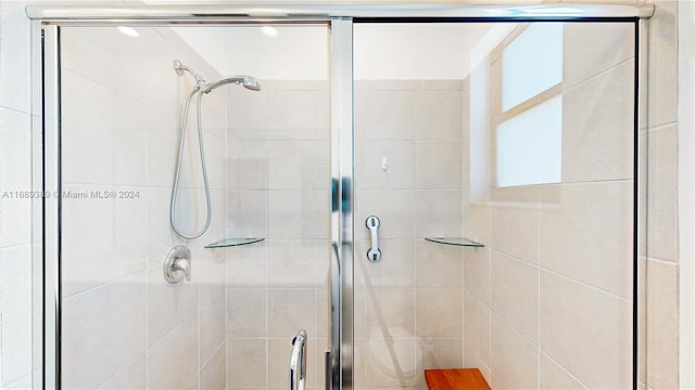 bathroom featuring a shower with shower door