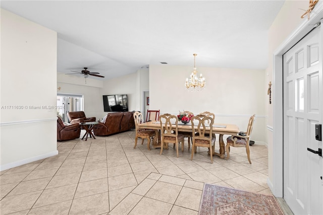 dining room featuring ceiling fan with notable chandelier, lofted ceiling, and light tile patterned flooring