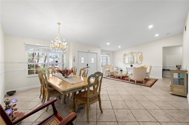 tiled dining room featuring lofted ceiling and a notable chandelier