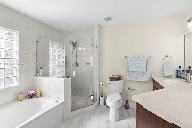 full bathroom with vanity, separate shower and tub, and toilet