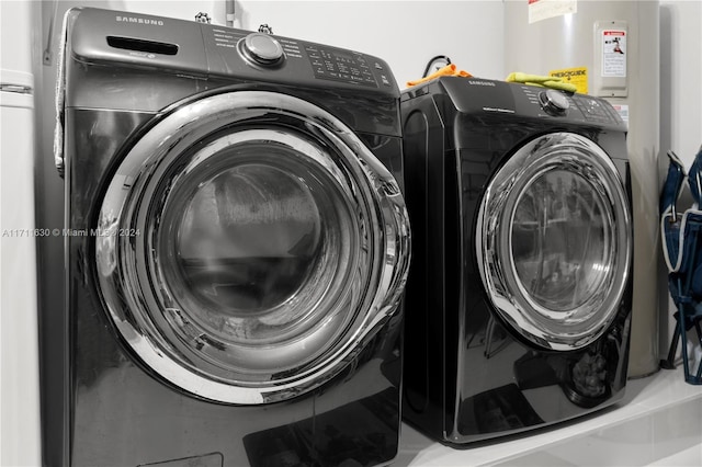 clothes washing area with washing machine and clothes dryer