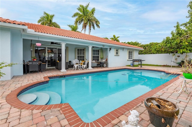 view of pool featuring a patio area, ceiling fan, and a grill